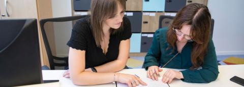 deux femmes regardant un cahier